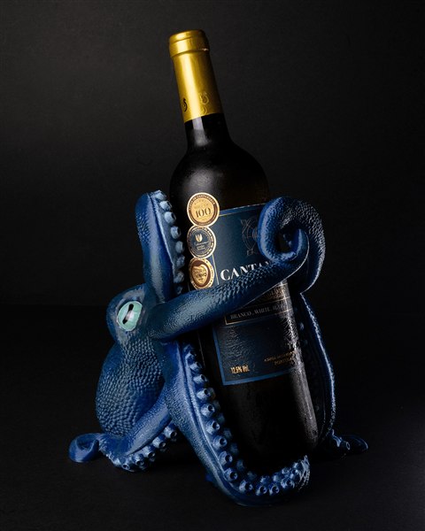 Blue octopus wine bottle holder holding a wine bottle